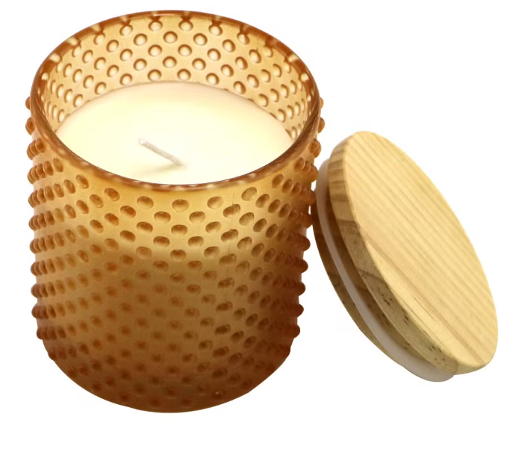 artisan pouring soy wax into wooden holder